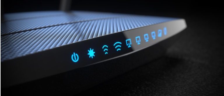 Black network router with blue icon lights.