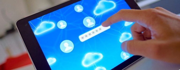 Hand entering password to cloud service on tablet device.