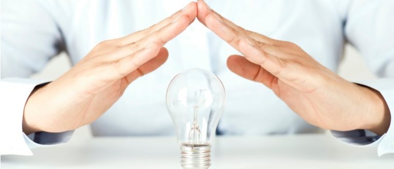 Hands Protecting Light Bulb