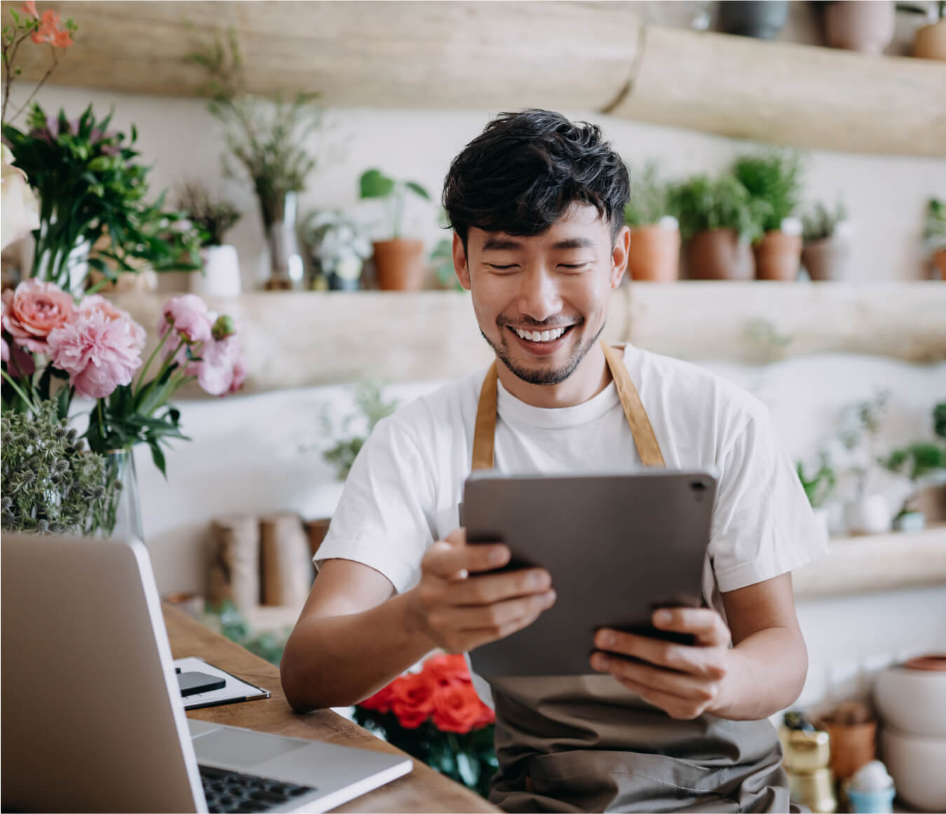 man in flower shop using internet