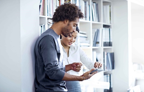 employees-collaborating-on-tablet-desktop